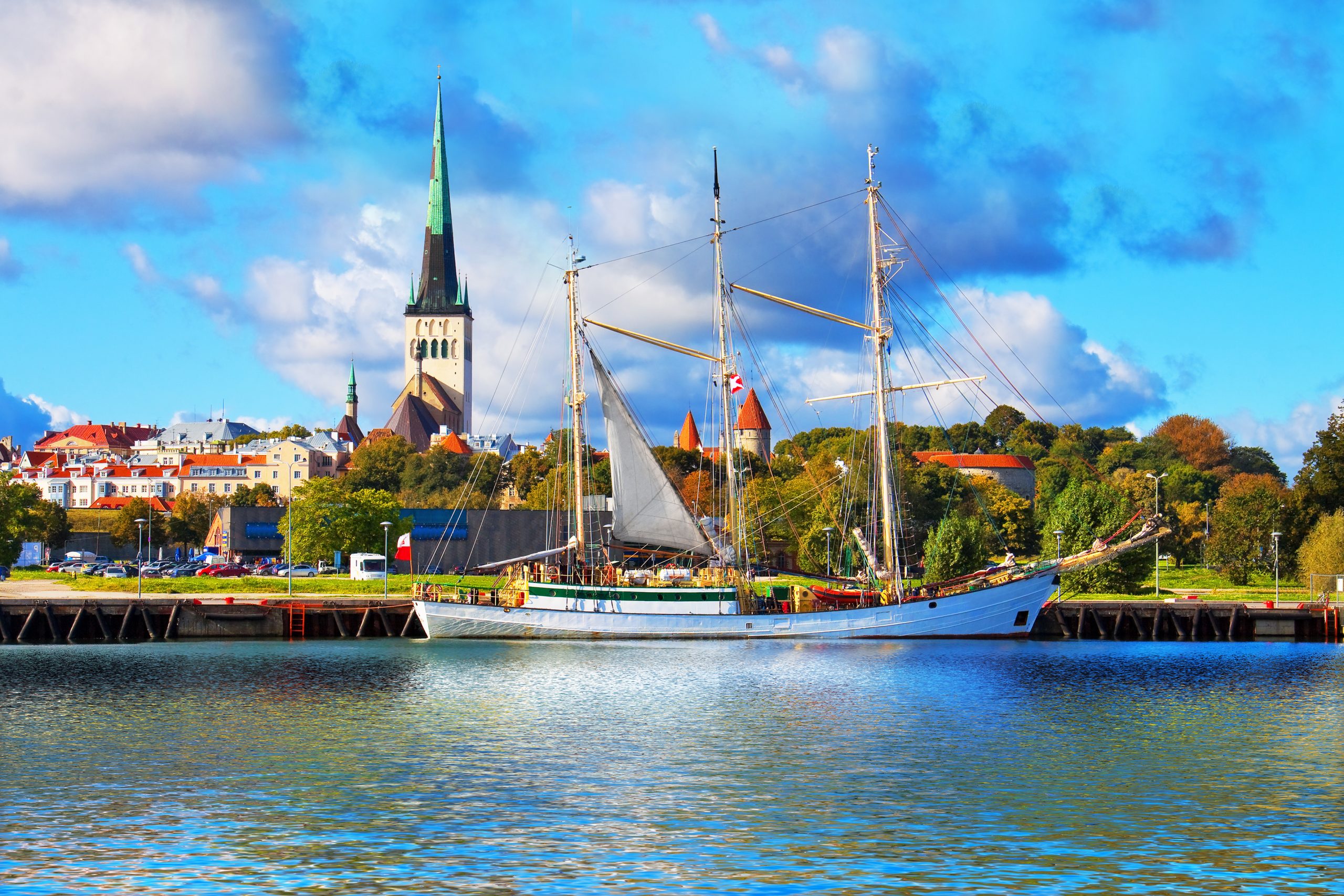 Scenic summer panorama of pier with historical tall sailing ship in the Old Town in Tallinn, Estonia